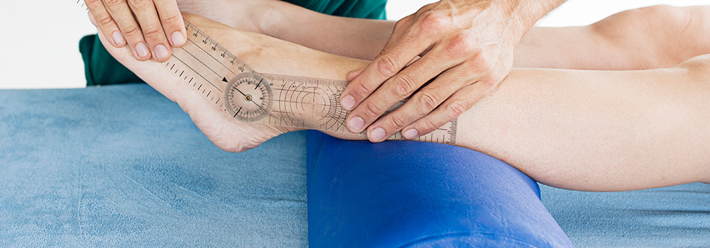 Physiotherapist assessing a patients foot injury